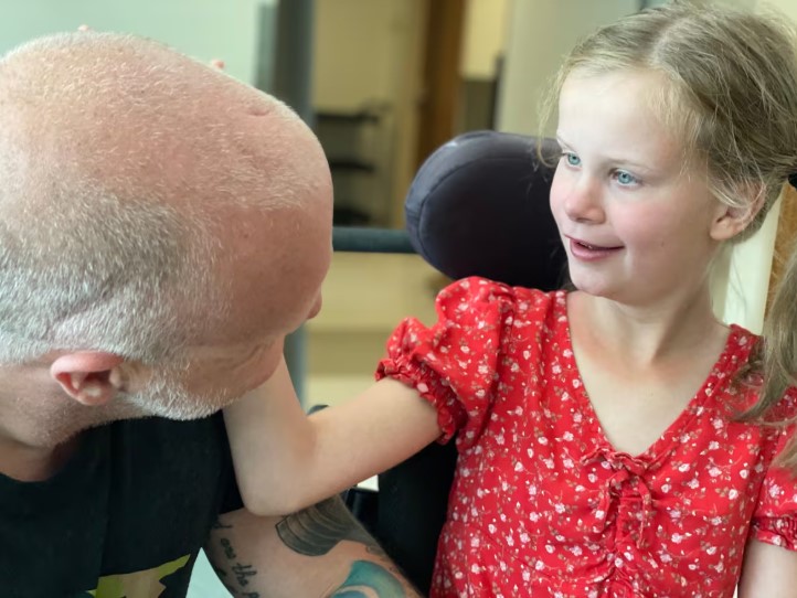 Jeff, with his daughter Irelynn. Irelynn is working to use a brain computer interface, technology that allows her to control objects by thought. 